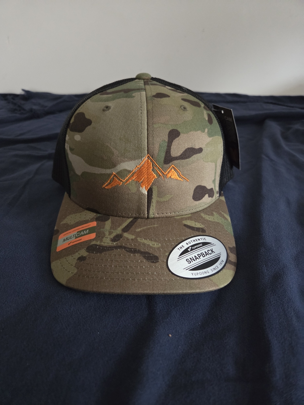 Camouflage Trucker Hat with Orange Mountain Embroidery